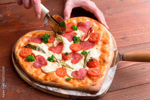 Obraz na płótnie pizza heart for the Valentine's Day holiday. classic Italian pizza with salami and mozzarella w salonie