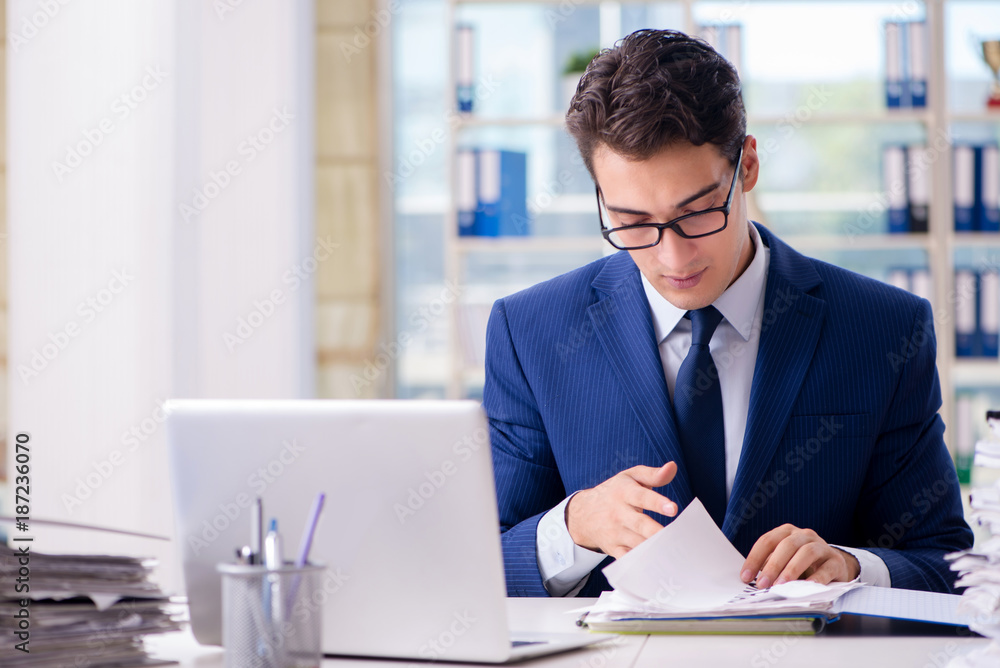Businessman working with paperwork in the office Businessman working with paperwork in the office