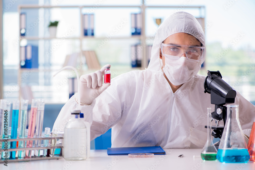 Chemist working in the laboratory with hazardous chemicals Chemist working in the laboratory with hazardous chemicals