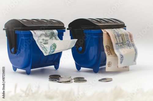 money in the garbage container blue photo