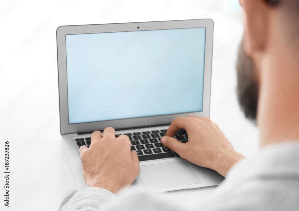 Young man using his laptop on white background Young man using his laptop on white background
