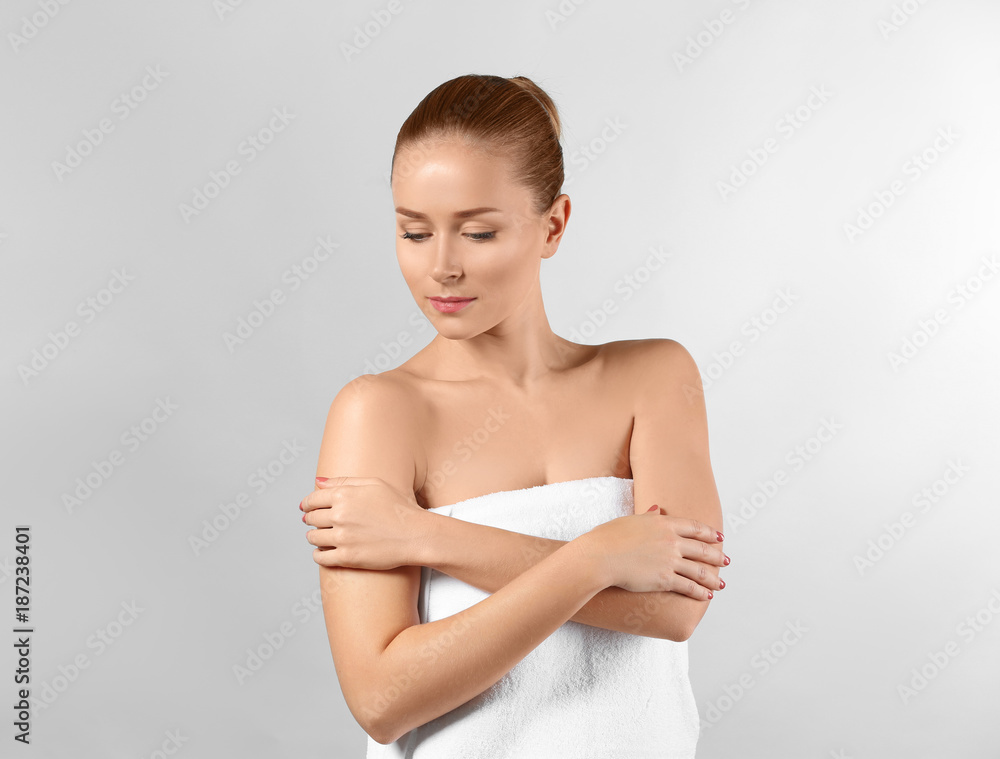 Beautiful young woman with soft skin on light background Beautiful young woman with soft skin on light background