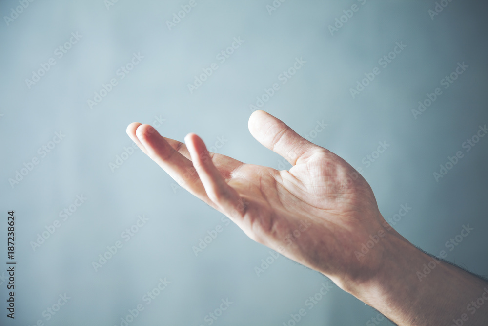 male is standing and shows outstretched hand with open palm male is standing and shows outstretched hand with open palm