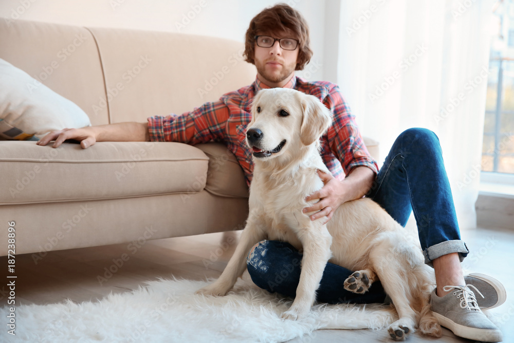 Handsome young hipster with dog at home Handsome young hipster with dog at home