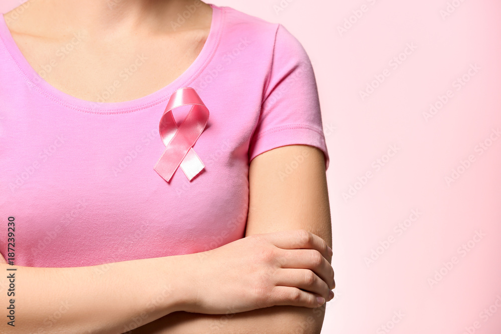 custom made wallpaper toronto digitalWoman with pink ribbon on t-shirt against color background. Breast cancer awareness concept