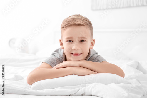 Cute boy lying on white pil...