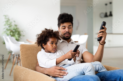 Father And Daughter Watching Television