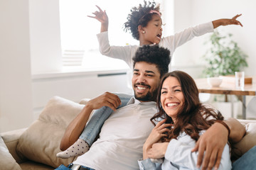 Family lifestyle portrait of a mum and dad with their kid