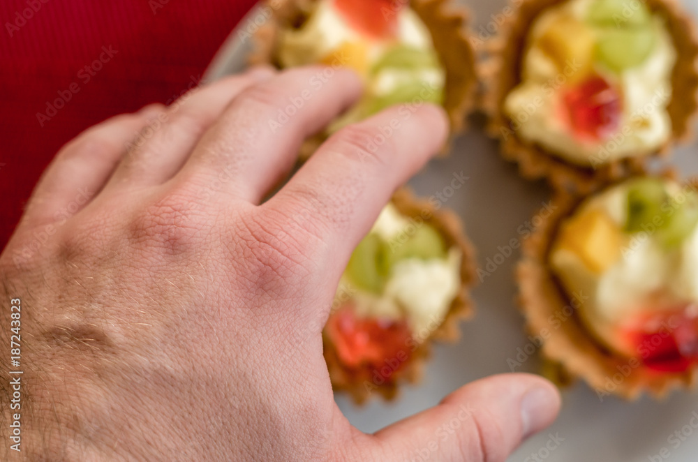 Hand reaching cupcakes, New Year resolution Hand reaching cupcakes, New Year resolution