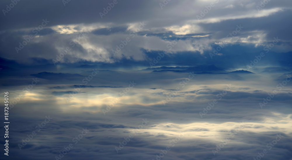 Flying above a sea of clouds in the evening sky