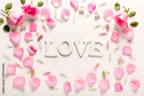 Love theme with rose petals and and wooden letters