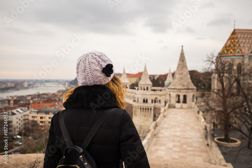 Young woman is admiring the sight of Fisherman Bastion and Matthias Church in Budapest, Hungary