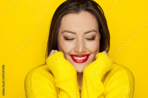 beautiful sexy woman in a yellow blouse on a yellow background