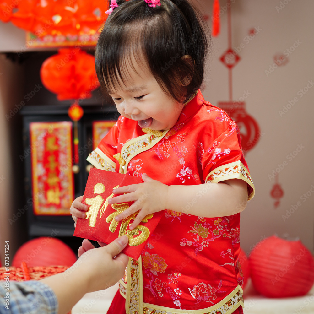 Chinese baby girl traditional dressing up get FU means lucky red envelope Chinese baby girl traditional dressing up get FU means lucky red envelope