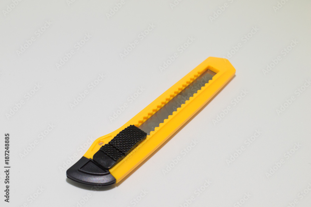Yellow and black boxcutter tool icon. Household box cutter instrument for  general or utility purposes. Snap-off blade stationery knife Stock Photo
