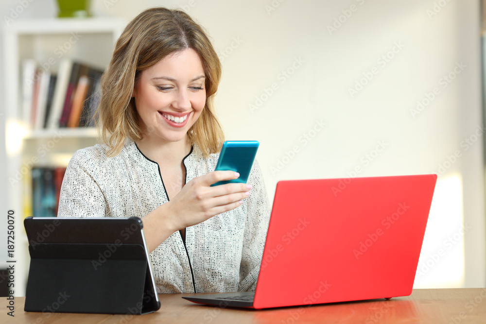 Blonde woman using multiple devices at home Blonde woman using multiple devices at home