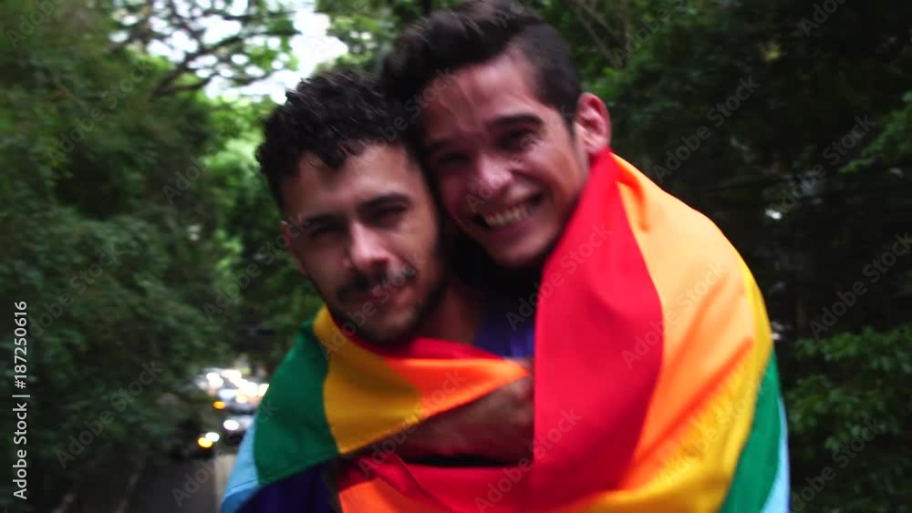 Gay Couple Piggybacking with Rainbow Flag Gay Couple Piggybacking with Rainbow Flag