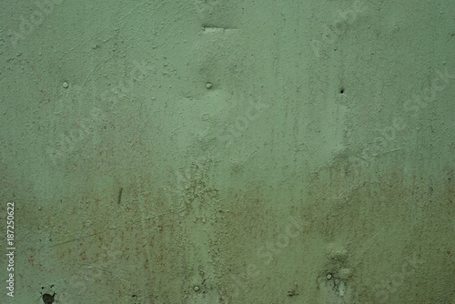 Old iron surface is painted green paint - bright rustic metal background