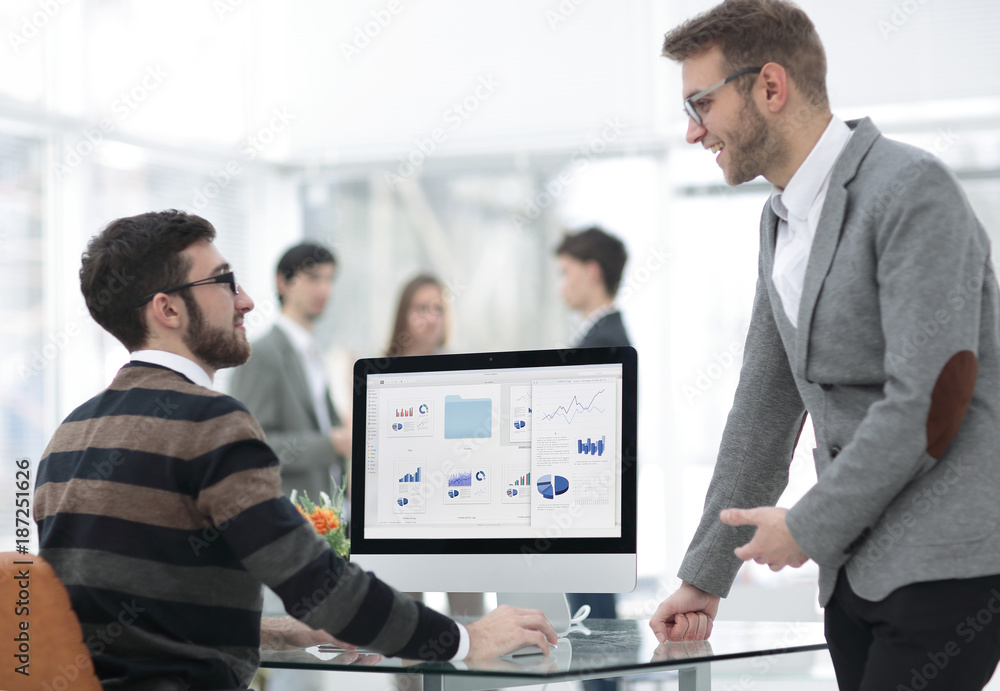 Fototapeta premium two businessmen analyzing stats financial data