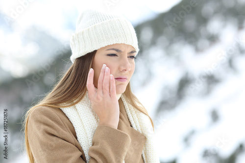 Fotótapéta Angry woman using a sking protection cream in winter