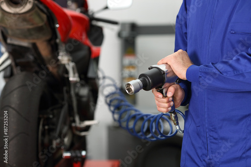 Mechanic hand holding a pneumatic gun