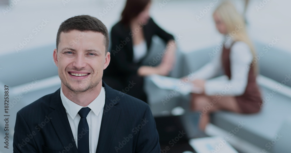 Portrait of business man looking at camera on the background of Portrait of business man looking at camera on the background of