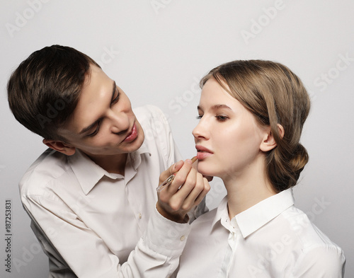 The makeup artist does makeup for young model