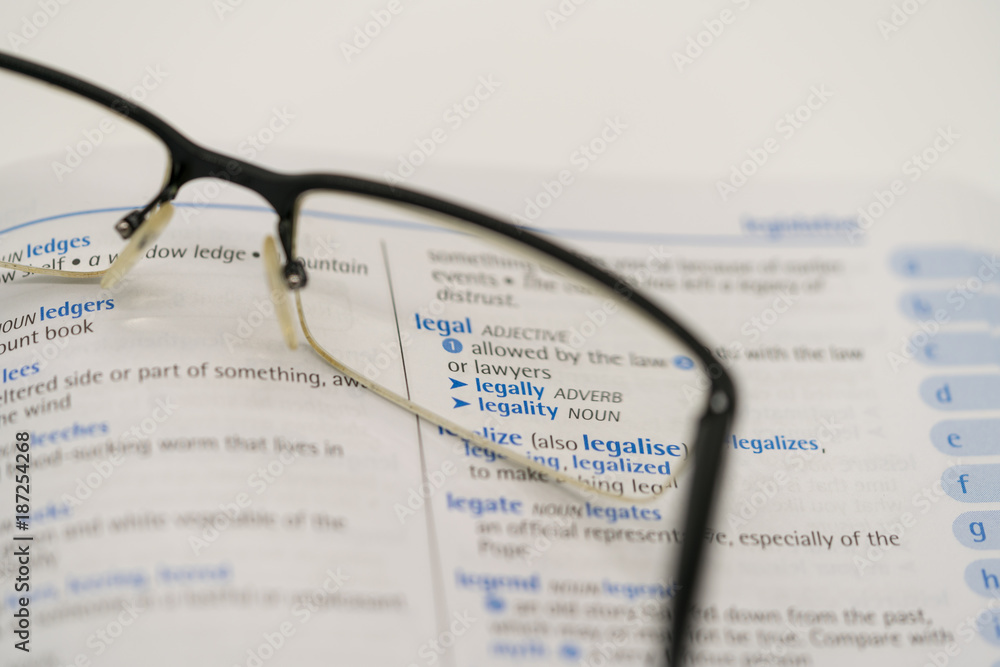 Dictionary showing the word legal through a pair of reading glasses Dictionary showing the word legal through a pair of reading glasses