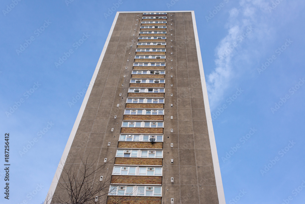 Tall council flat tower block of apartments in brutalist style viewed from below Tall council flat tower block of apartments in brutalist style viewed from below