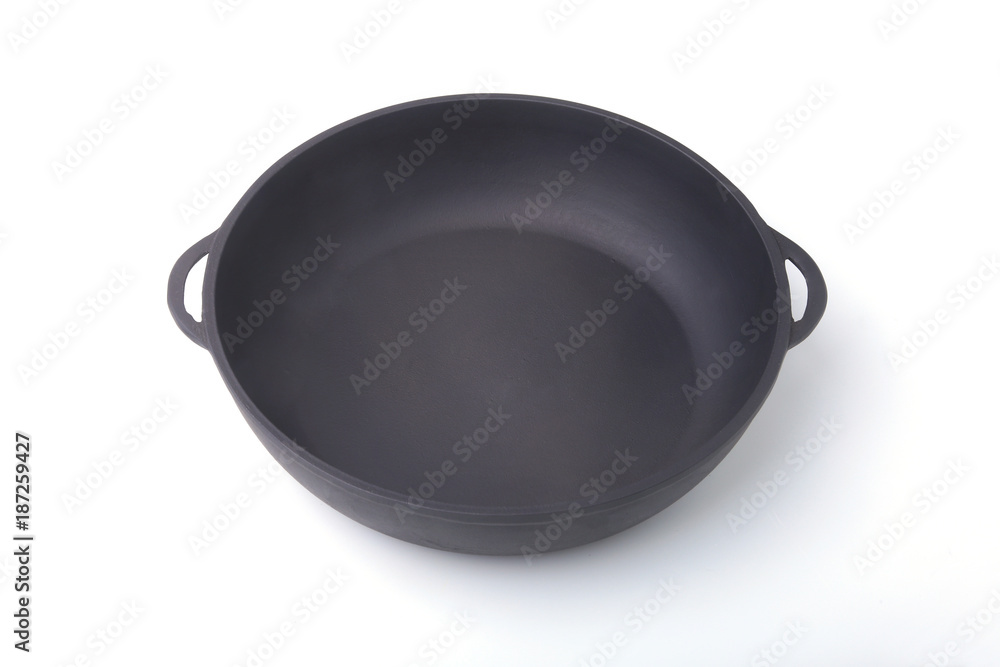 A new, clean and empty cast-iron pan for the grill. A new, clean and empty cast-iron pan for the grill.