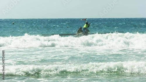 a surf boat goes over a wave during a men's final at the 2016 australian national championships photo