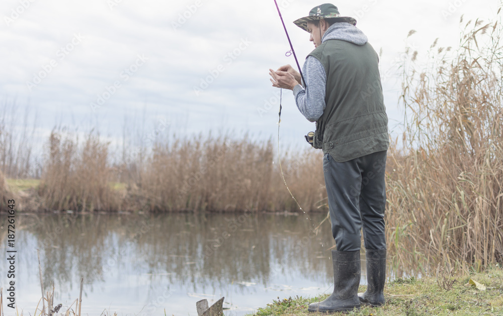 A man enjoys in the free time he spends himself on fishing A man enjoys in the free time he spends himself on fishing