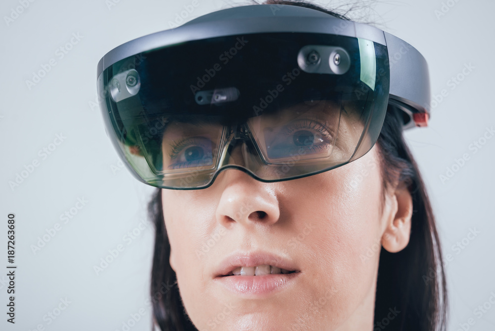 Woman wearing augmented reality goggles. Woman wearing augmented reality goggles.
