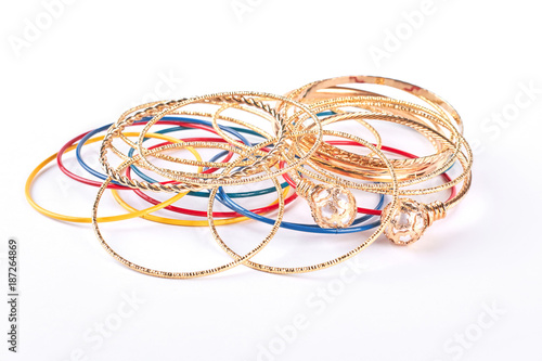 Golden bracelets on white background. Collection of female fashion wrist bands. Women hand accessories.