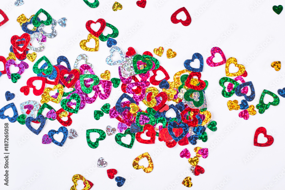 Shiny heart paper confetti. Many glittering multicolored paper hearts confetti on white background. Wedding or Valentine day decoration. Shiny heart paper confetti. Many glittering multicolored paper hearts confetti on white background. Wedding or Valentine day decoration.