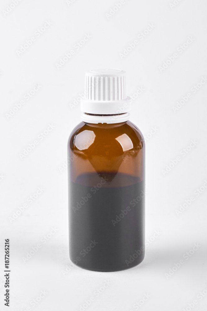 Bottle with cough syrup, white background. Medical liquid in glass brown bottle on white background, front view. Bottle with cough syrup, white background. Medical liquid in glass brown bottle on white background, front view.