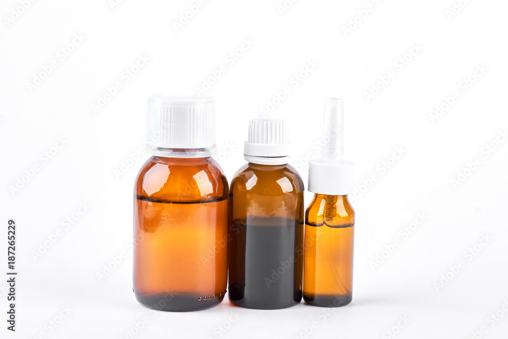Composition of bottles with medical liquid. Three brown glass bottles with medicine isolated on white background. Composition of bottles with medical liquid. Three brown glass bottles with medicine isolated on white background.