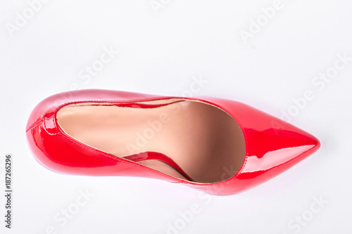 Female red shoe, top view. Woman lacquered shoe on high heel isolated on white background.