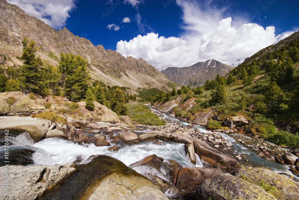 View of the waterfall near a mountain lake Darashkol, Mountain Altai, Siberia, Russia.