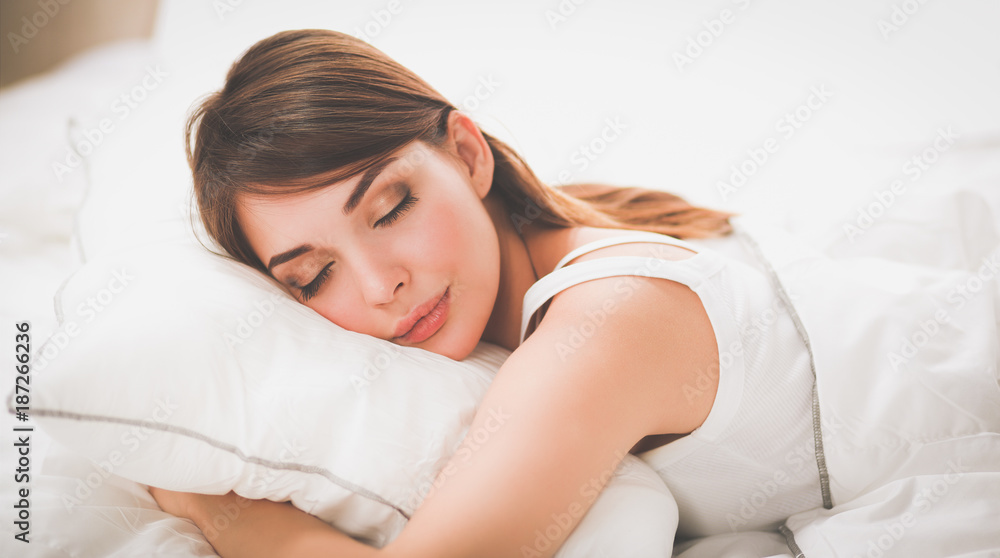 Beautiful girl sleeps in the bedroom, lying on bed Beautiful girl sleeps in the bedroom, lying on bed