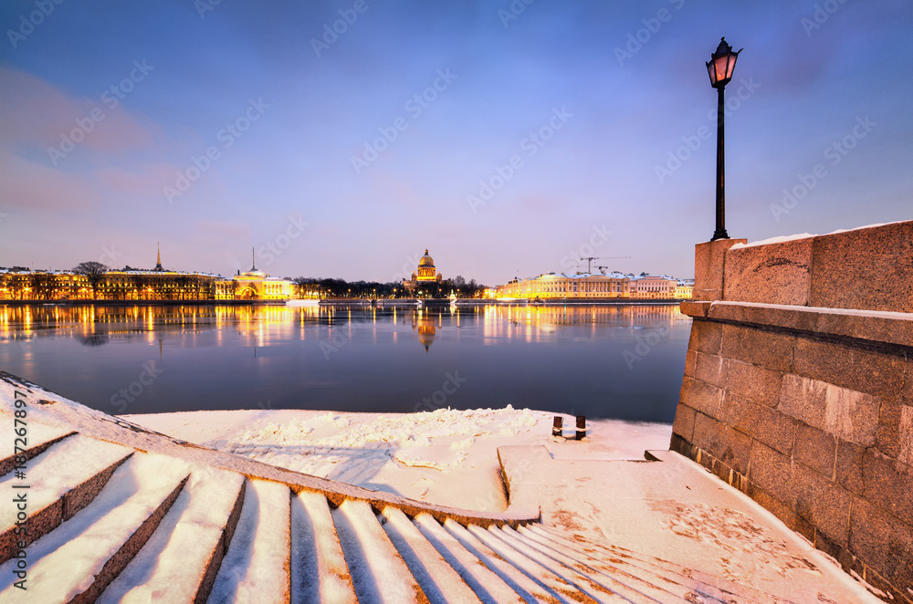 Saint Petersburg, Russia. Winter View from the University embankment to St. Isaac's Cathedral, Admiralty building and Neva river. A long exposure.