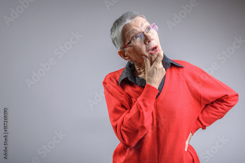 Senior old lady having troubles remembering something photo