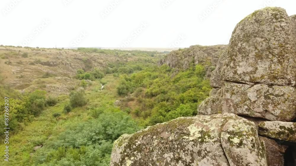 A mysterious view of a heap of huge stones placed together and looking like ancient fortress knights defending Ukraine in summer. A mysterious view of a heap of huge stones placed together and looking like ancient fortress knights defending Ukraine in summer.