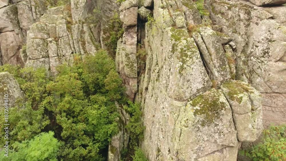 An inspiring view of some rocky hills with piles of round and cubic stones on them covering the Black Sea coast in Ukraine in summer. An inspiring view of some rocky hills with piles of round and cubic stones on them covering the Black Sea coast in Ukraine in summer.