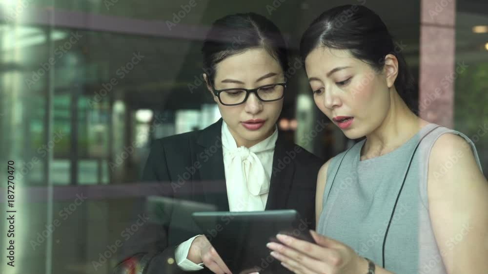 women discussion together with touchpad