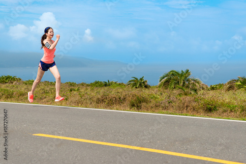attractive beauty girl athlete running on road