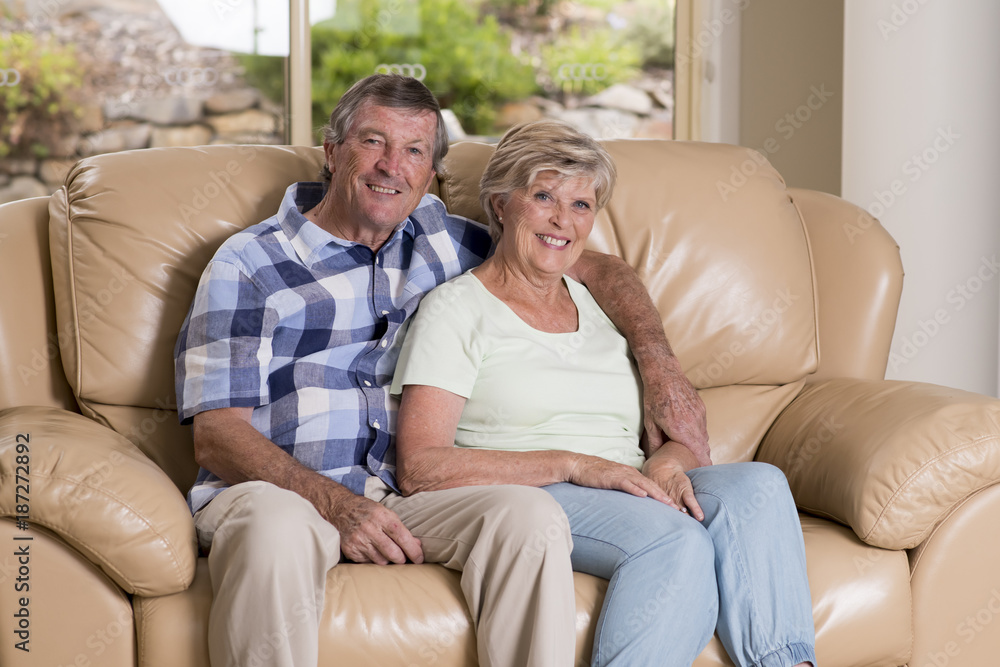 senior beautiful middle age couple around 70 years old smiling happy together at home living room sofa couch looking sweet in lifetime love