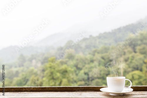Coffee cup and smoke with copy space background green mountain nature.