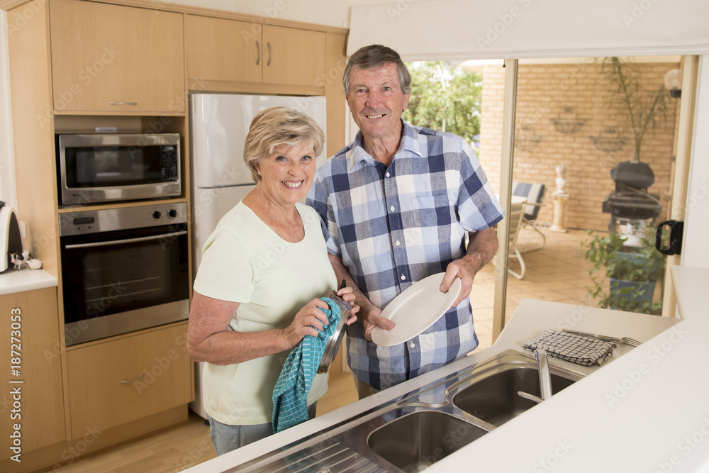 senior beautiful middle age couple around 70 years old smiling happy at home kitchen washing the dishes looking sweet together senior beautiful middle age couple around 70 years old smiling happy at home kitchen washing the dishes looking sweet together