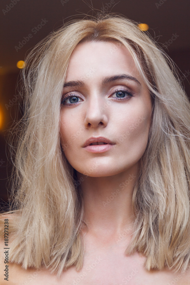 Close-up portrait of a gorgeous young blonde woman with straight cut hairstyle, green mysterious eyes looking at you through the lens, big sexy lips and completely unveiled. Close-up portrait of a gorgeous young blonde woman with straight cut hairstyle, green mysterious eyes looking at you through the lens, big sexy lips and completely unveiled.